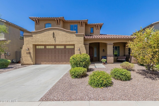 mediterranean / spanish-style home with a garage