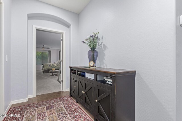 hall featuring dark tile patterned flooring