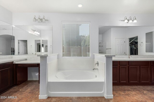 bathroom featuring vanity and shower with separate bathtub