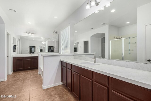 bathroom with vanity, tile patterned flooring, and a shower with door