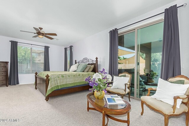 carpeted bedroom with ceiling fan and access to exterior