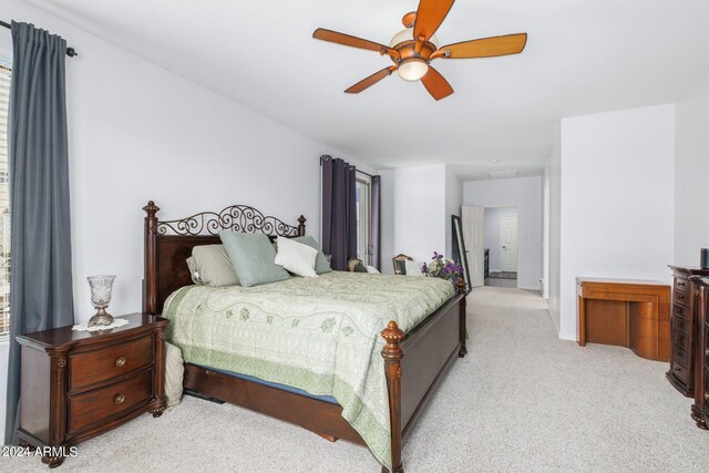 bedroom featuring ceiling fan and light carpet