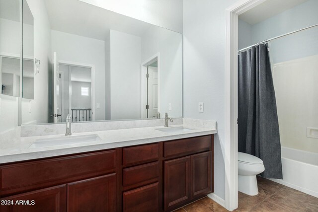 full bathroom featuring shower / bath combo with shower curtain, tile patterned flooring, vanity, and toilet