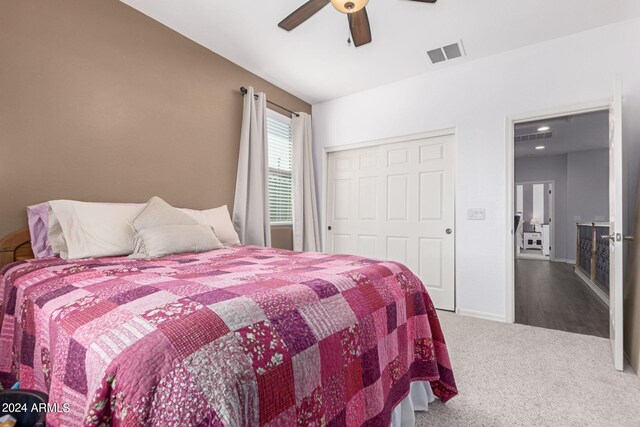 bedroom featuring a closet, ceiling fan, and carpet flooring