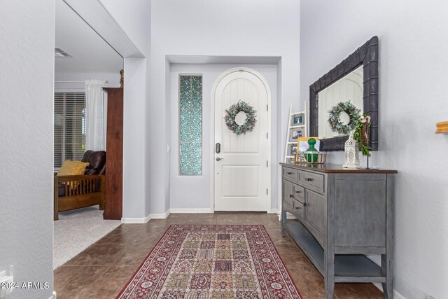 entryway featuring dark tile patterned floors