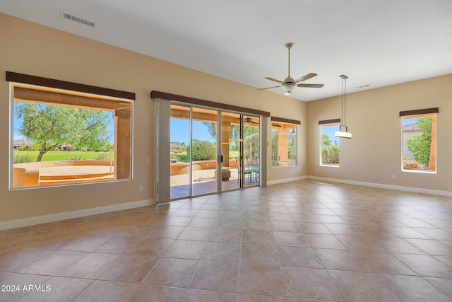 tiled empty room with ceiling fan