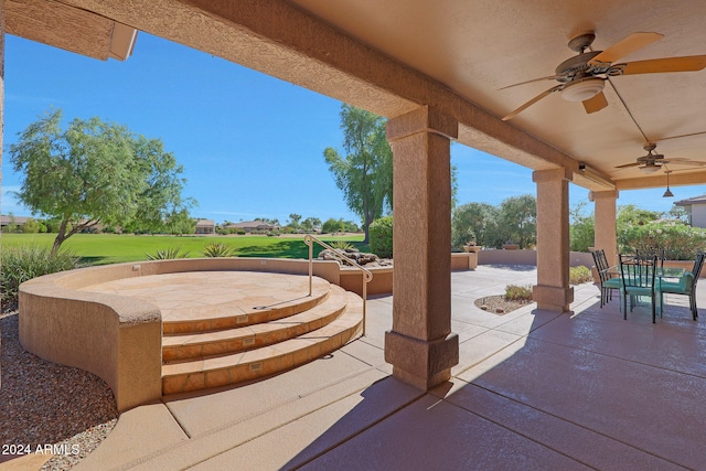 view of patio featuring ceiling fan and a hot tub