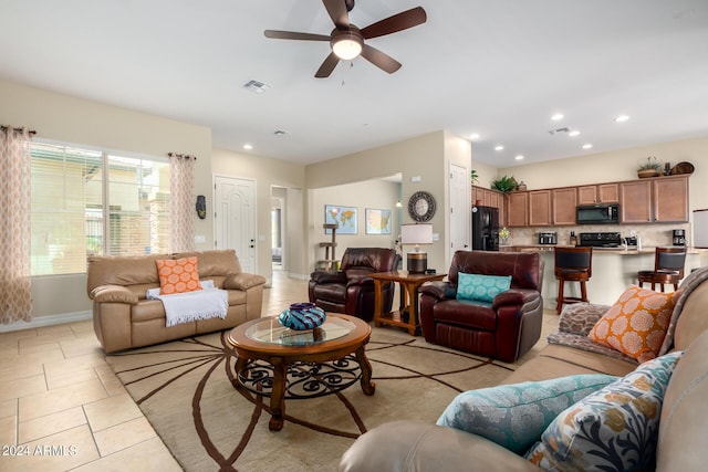 tiled living room with ceiling fan