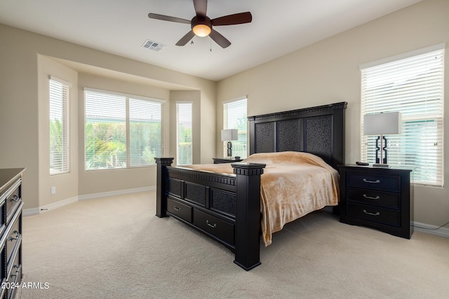 carpeted bedroom with multiple windows and ceiling fan