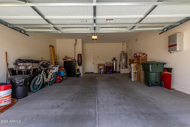 garage with water heater and a garage door opener