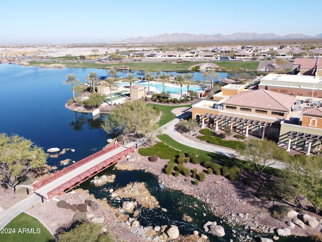 birds eye view of property with a water and mountain view