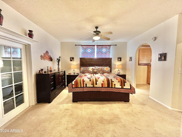 bedroom with light carpet, multiple windows, and access to outside