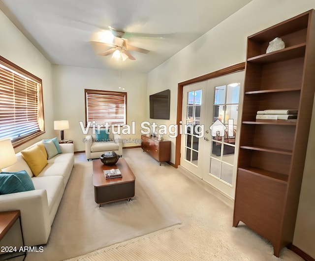 living room featuring light colored carpet, ceiling fan, and french doors