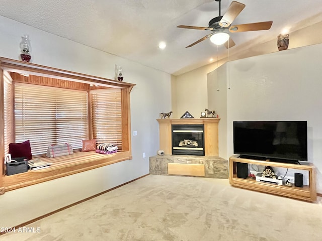 living room with vaulted ceiling, ceiling fan, and carpet flooring