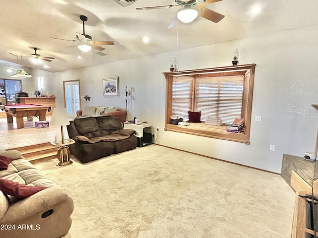 carpeted living room with lofted ceiling, a healthy amount of sunlight, and a textured ceiling