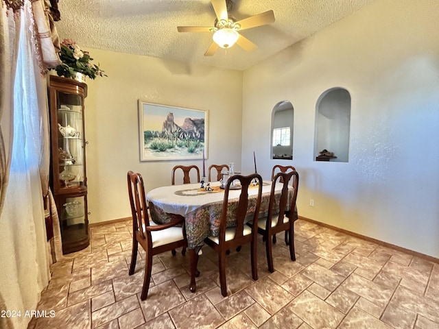 dining room with ceiling fan and a textured ceiling