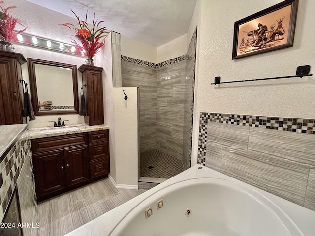 bathroom featuring vanity and separate shower and tub