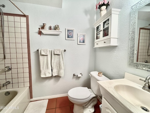 full bathroom with vanity, tile patterned flooring, tiled shower / bath combo, and toilet