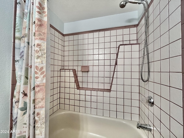 bathroom with shower / tub combo and a textured ceiling