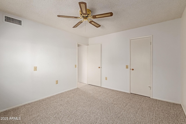 unfurnished bedroom featuring visible vents, baseboards, carpet, and a textured ceiling