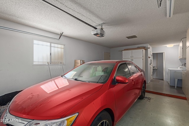 garage with a garage door opener and separate washer and dryer