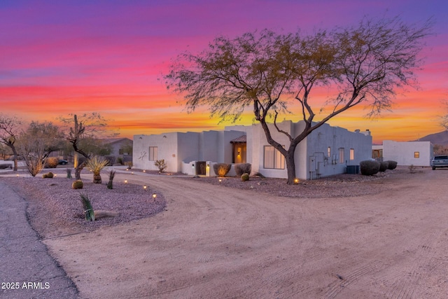 adobe home with central AC unit