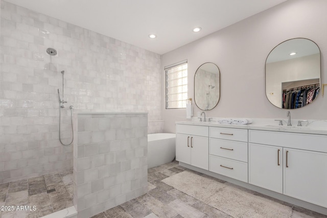 bathroom featuring vanity and shower with separate bathtub