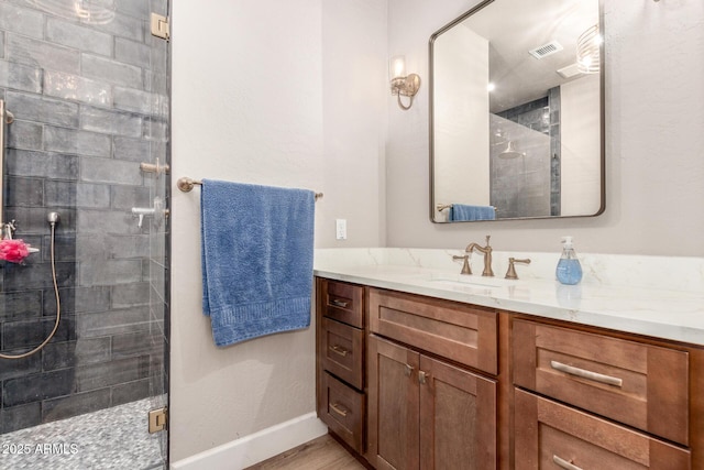 bathroom with vanity, hardwood / wood-style floors, and a shower with shower door