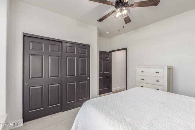 bedroom with light colored carpet, a closet, and ceiling fan