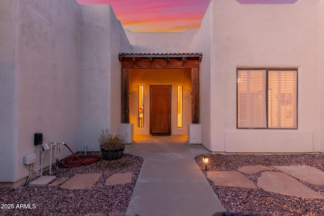 view of exterior entry at dusk