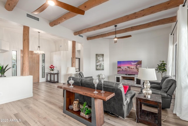 living room with beam ceiling, ceiling fan with notable chandelier, and light hardwood / wood-style flooring