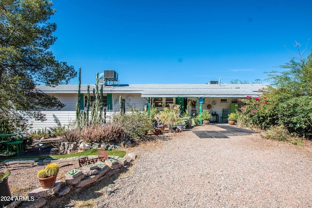 ranch-style home featuring central AC unit