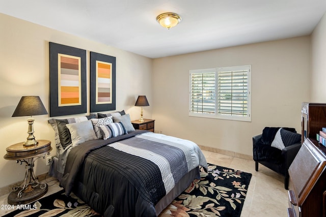 bedroom with light tile patterned floors