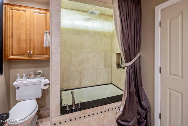 bathroom with shower / bath combination with curtain and toilet