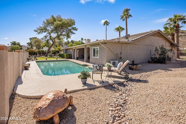 view of pool featuring ac unit and a patio area