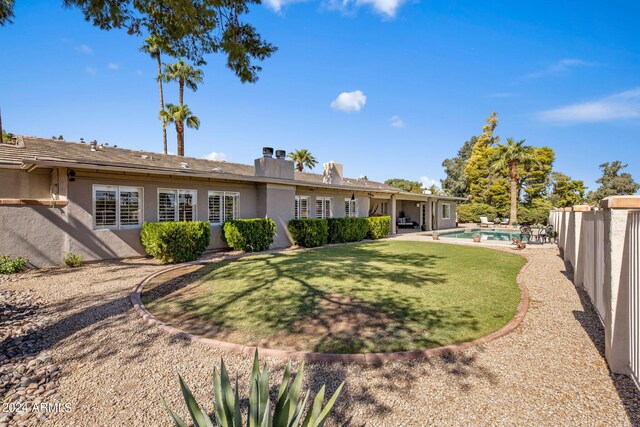 view of yard with a fenced in pool and a patio