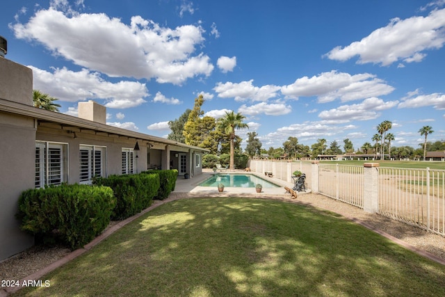 view of yard featuring a fenced in pool and a patio area