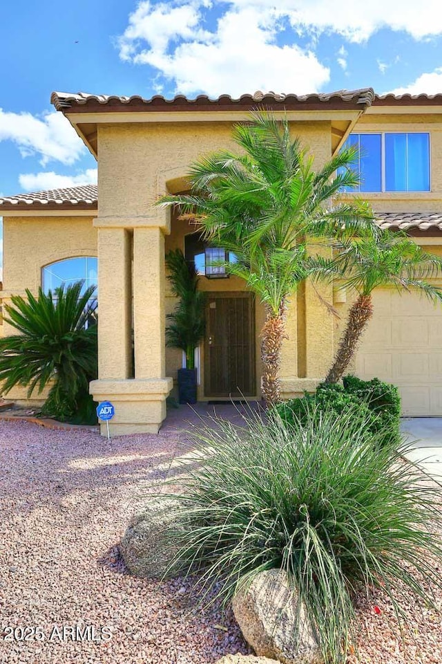 view of front of property with a tiled roof and stucco siding