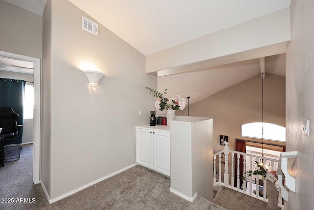 interior space with carpet floors, high vaulted ceiling, visible vents, and baseboards