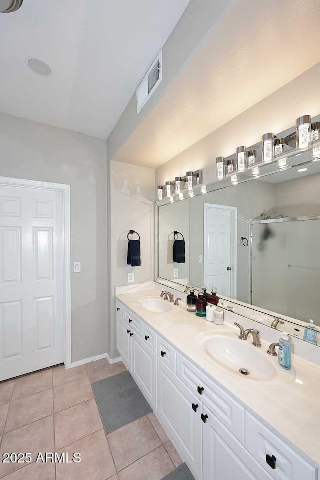 full bath featuring a shower stall, visible vents, a sink, and tile patterned floors