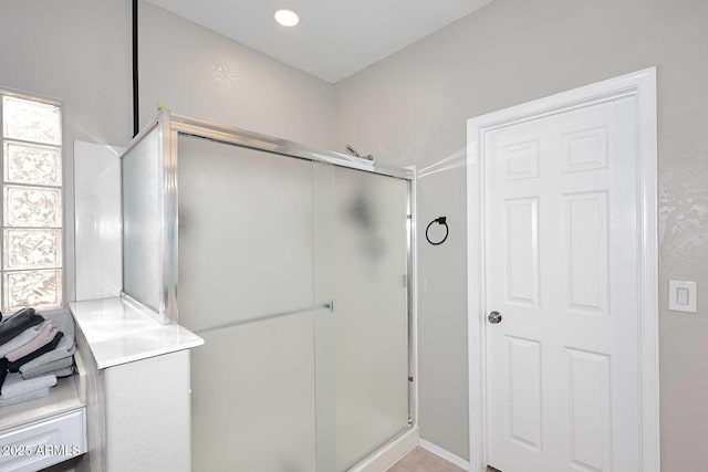 bathroom with a wealth of natural light, recessed lighting, and a shower stall