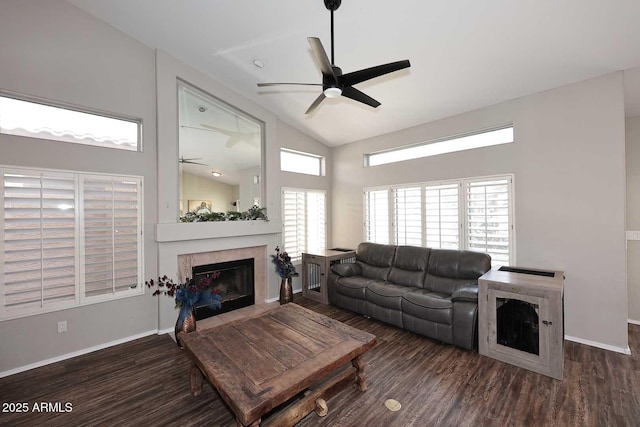 living room featuring a ceiling fan, a fireplace, and wood finished floors