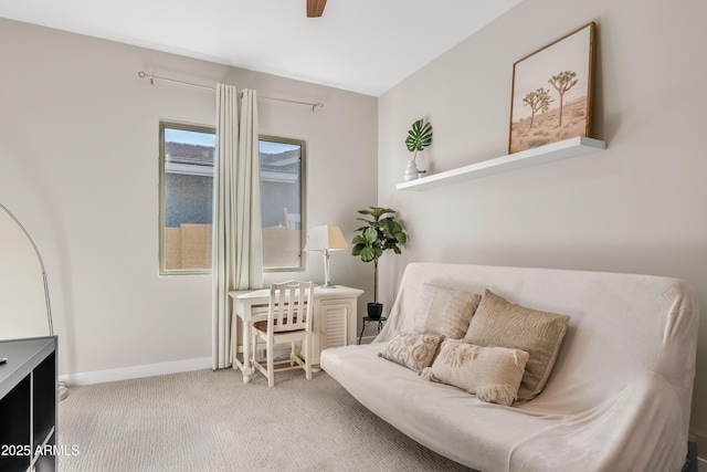 sitting room featuring carpet flooring and baseboards