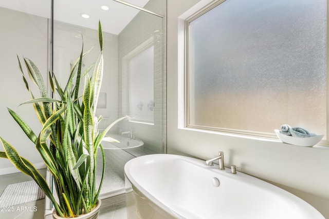 full bathroom with recessed lighting and a freestanding bath