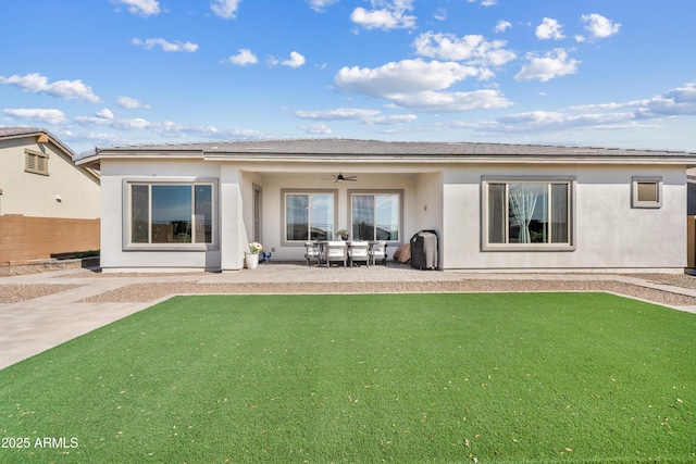 rear view of house featuring stucco siding, a patio, ceiling fan, and fence