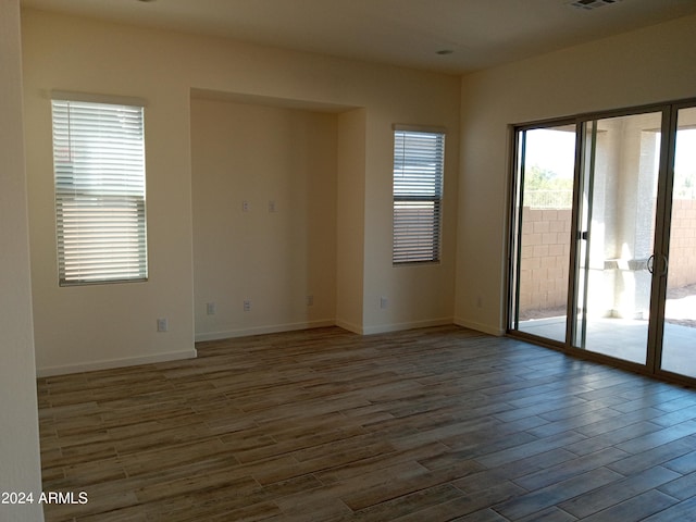 unfurnished room featuring hardwood / wood-style floors