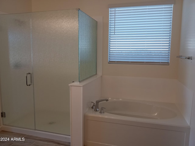 bathroom featuring independent shower and bath