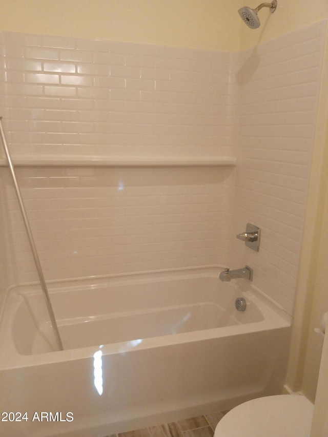 bathroom featuring toilet and washtub / shower combination