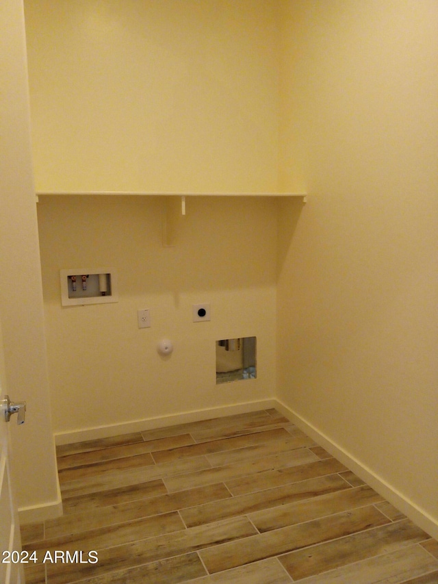 clothes washing area featuring hookup for a washing machine, hookup for an electric dryer, gas dryer hookup, and hardwood / wood-style floors