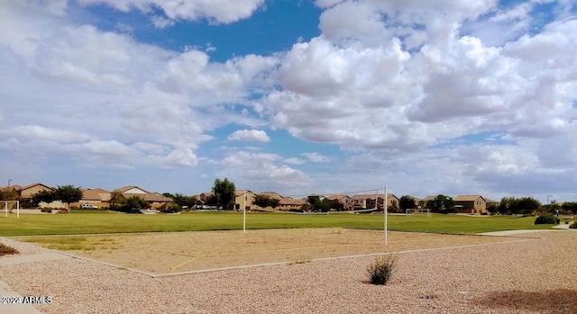 surrounding community with a lawn and volleyball court